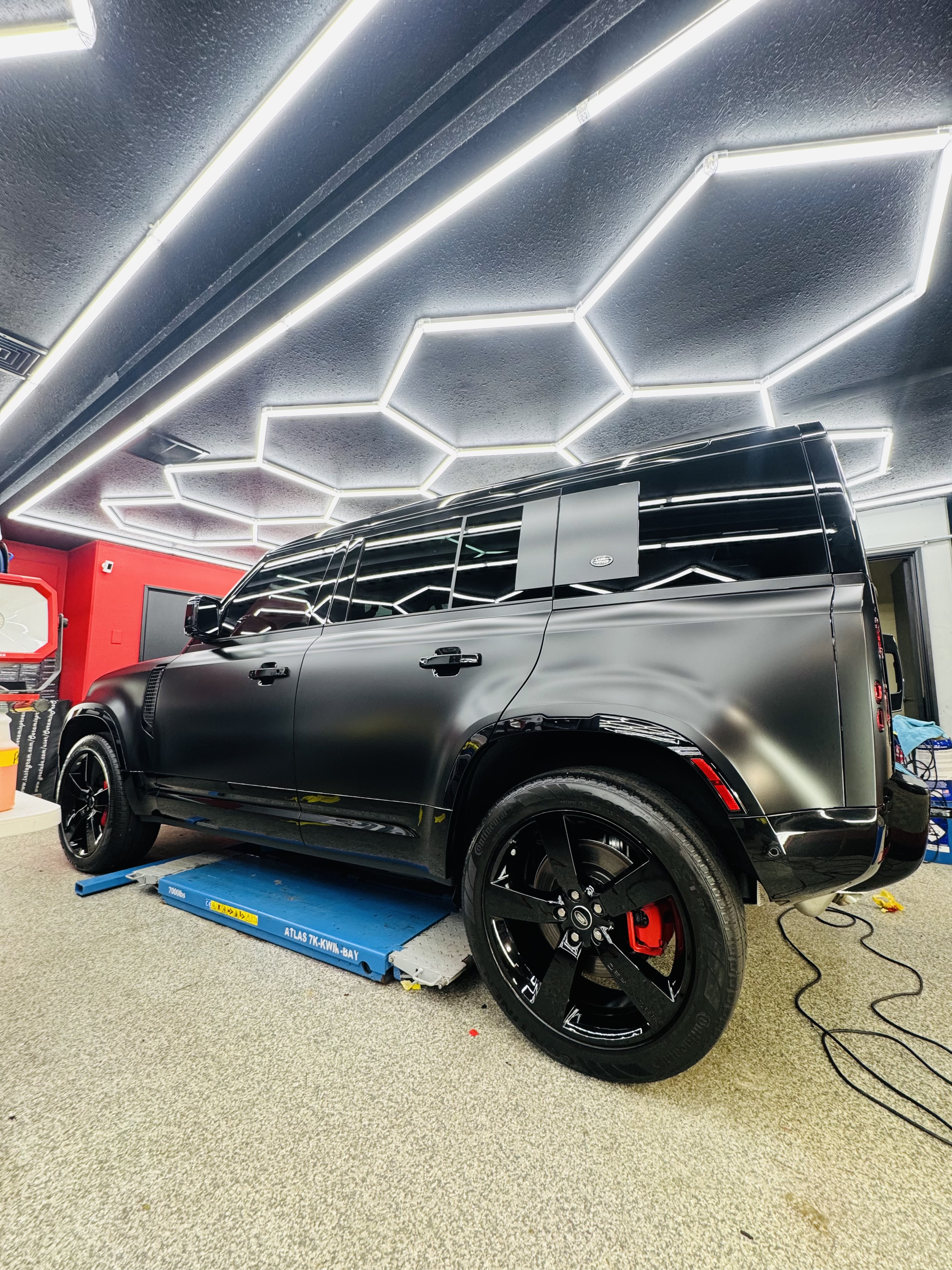 Black Land Rover Defender with satin wrap