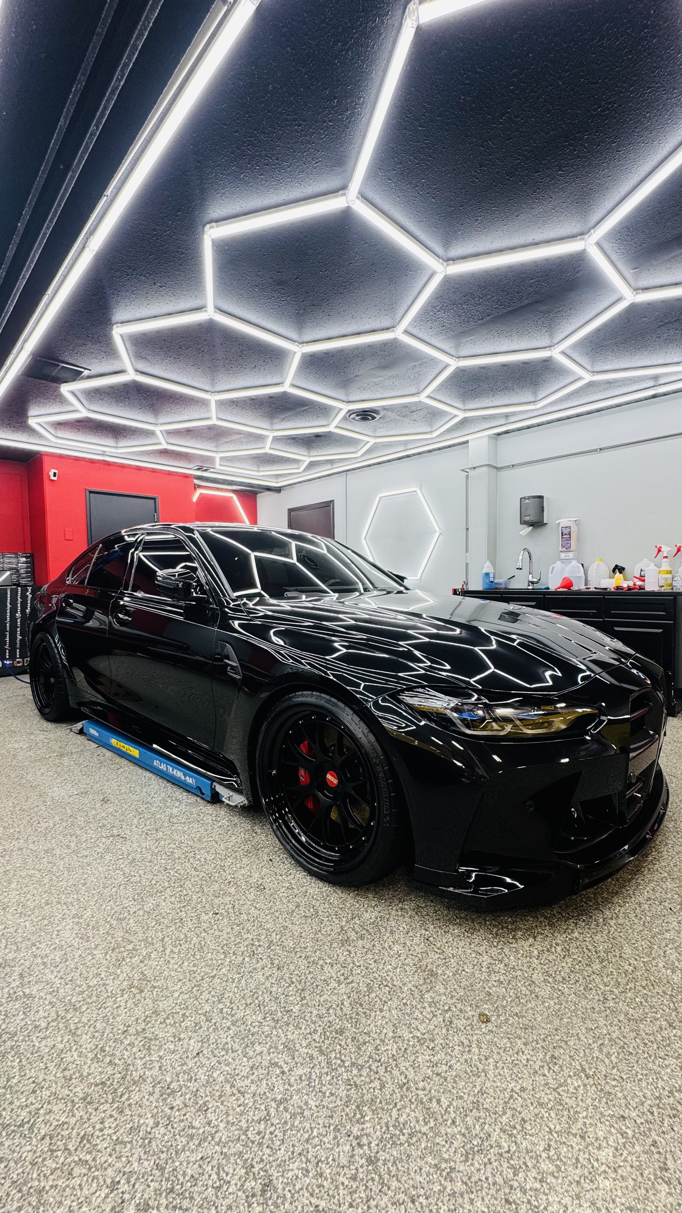 Black BMW M3 under hexagon lights