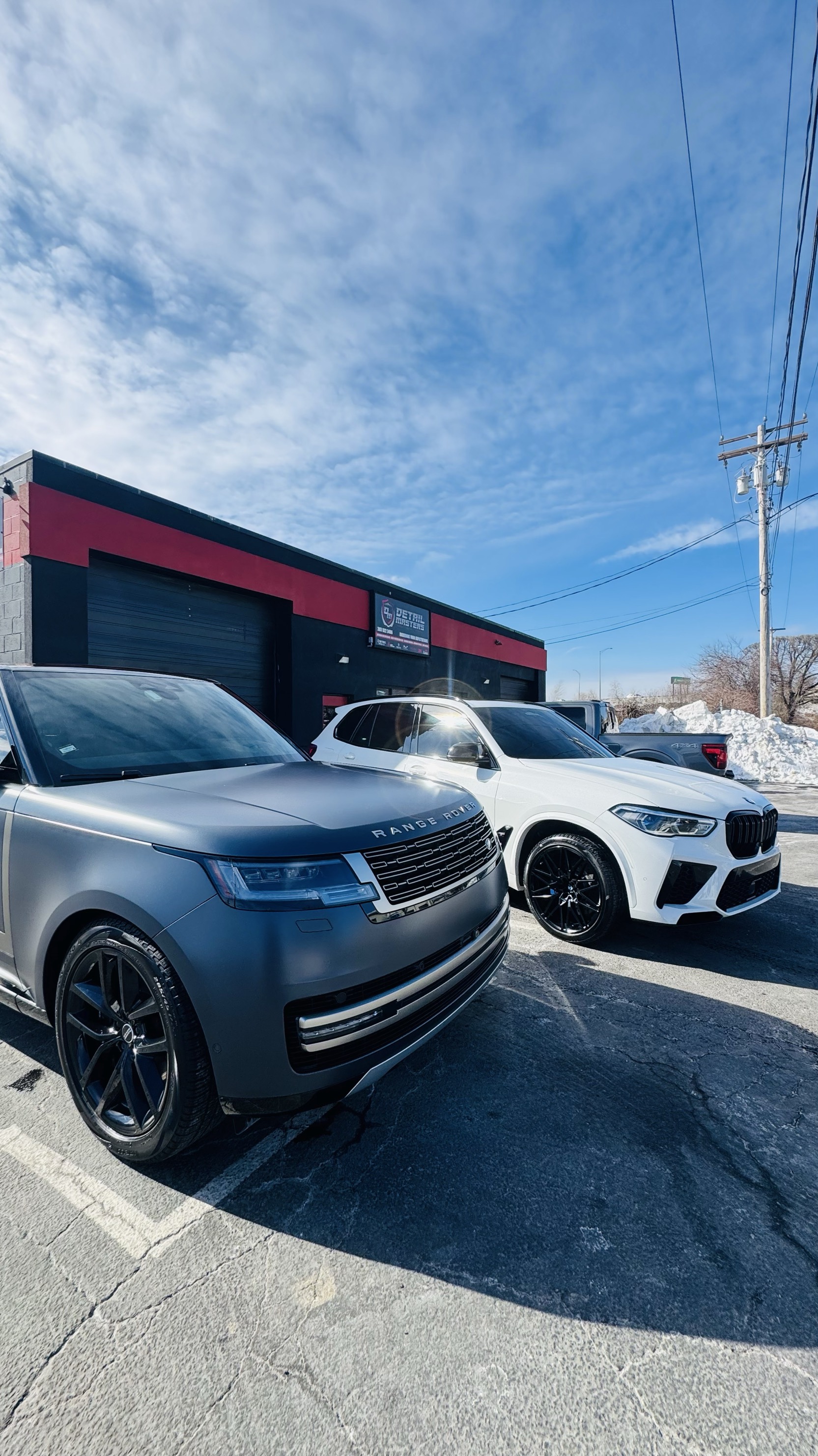 Detail Masters storefront with Range Rover and BMW X5 M